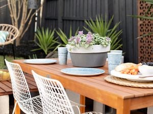 Painted terracotta pot on an outdoor dining table