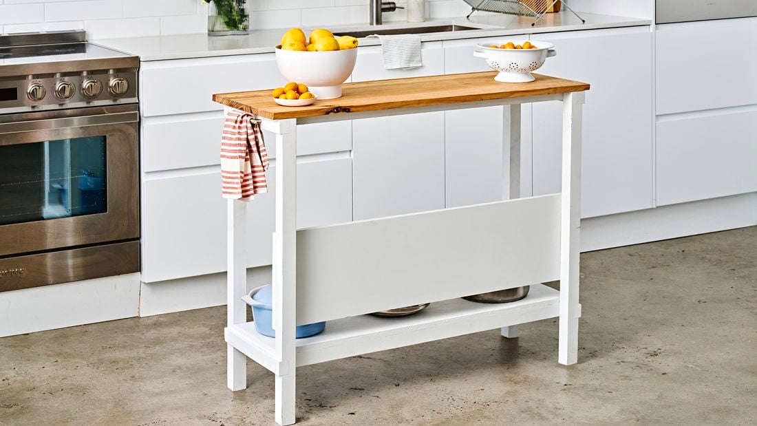 Kitchen trolley with pots, bowls and tea towel in modern kitchen