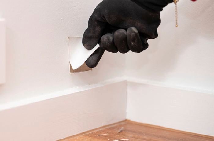 A person taking a paint chip sample for colour matching