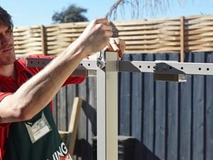 Attaching the universal bracket to the post of a retractable clothesline.