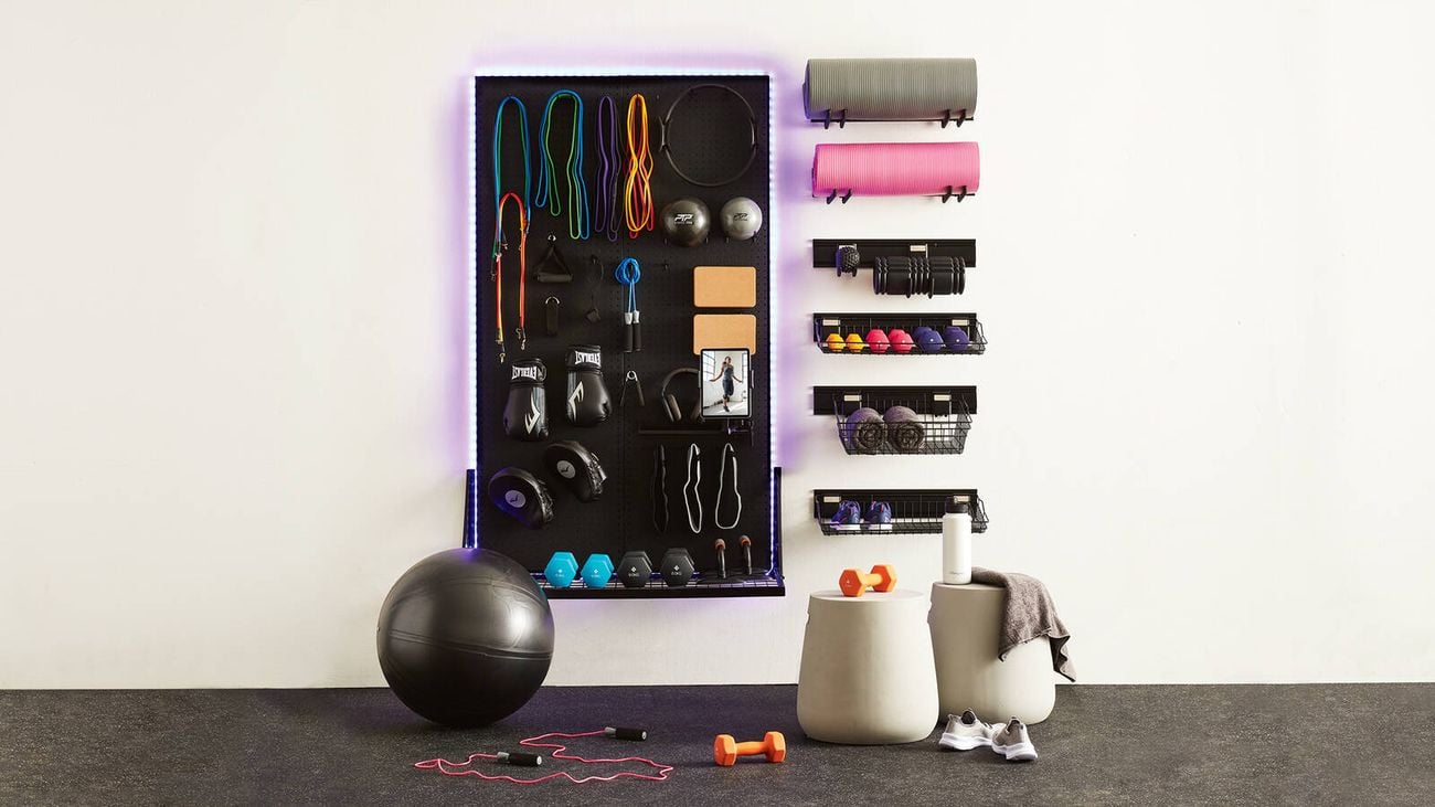 Wall-mounted pegboard, baskets and hooks for home gym and exercise equipment