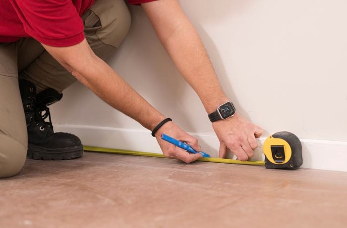 Mark the stud wall position with a tape measure and pencil. 