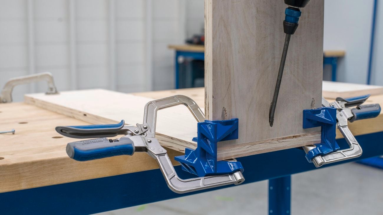 Timber being held together by a clamp.