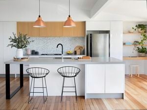 Kitchen with white and timber cabinets, and grey benchtops.