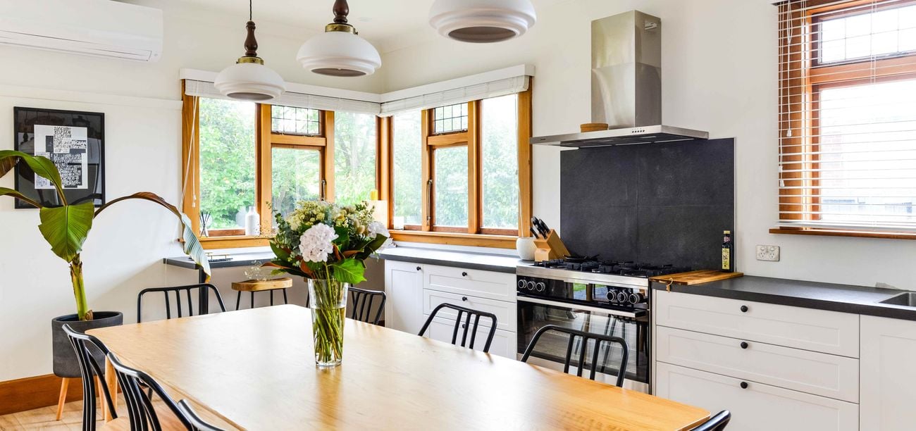 kitchen and dining table with a vase on it