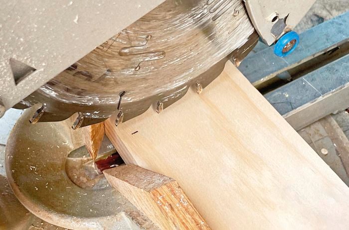 Piece of timber being cut with mitre saw