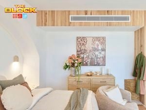 Bedroom featuring a curved oak timber cladding wall that flows seamlessly into creating a warm and contemporary architectural feature.