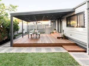 Outdoor deck at the back of a house with outdoor furniture