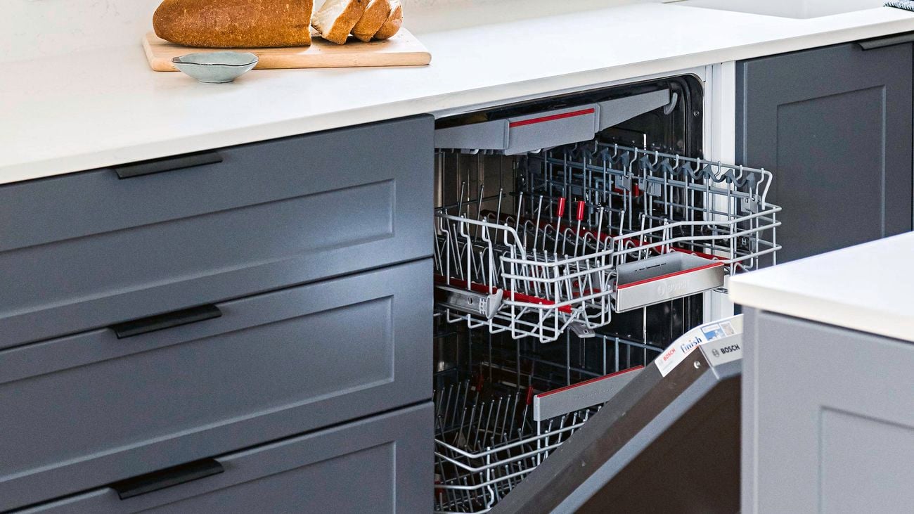 Blue and white kitchen with dishwasher partially open