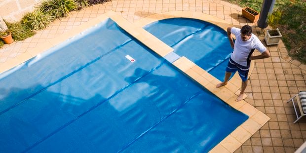 man standing near a pool
