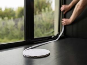 Person installing weather seals to window.