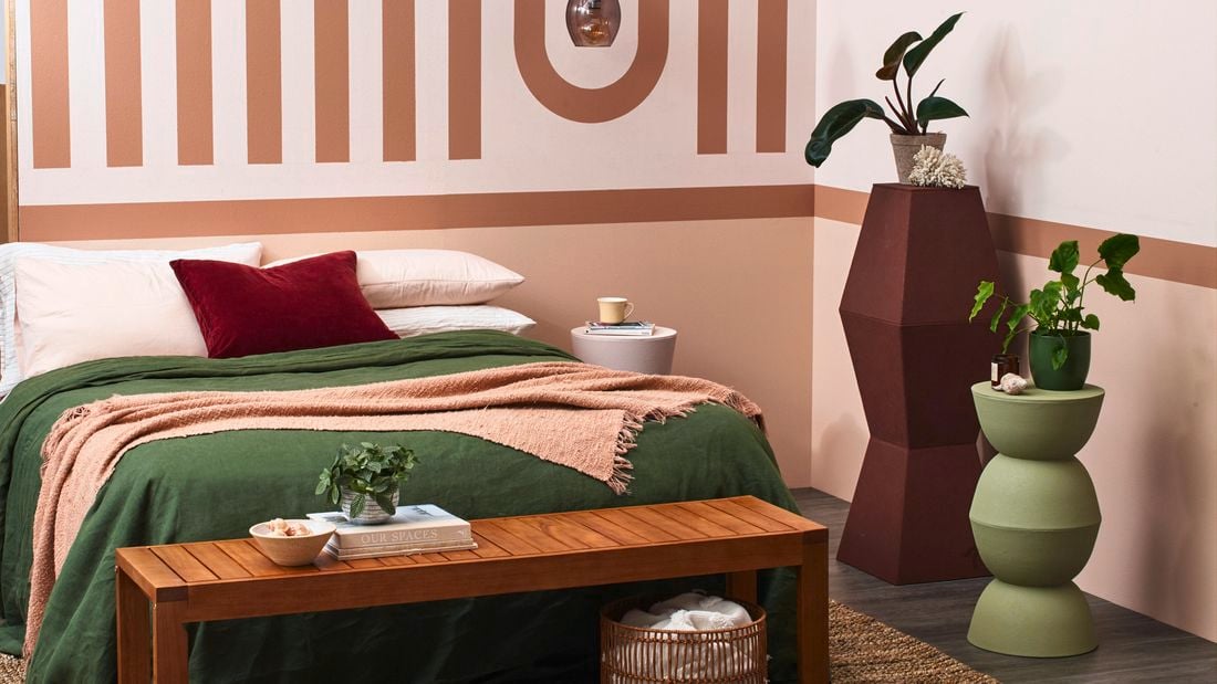 Bedroom with earthy tones and a geometric feature wall