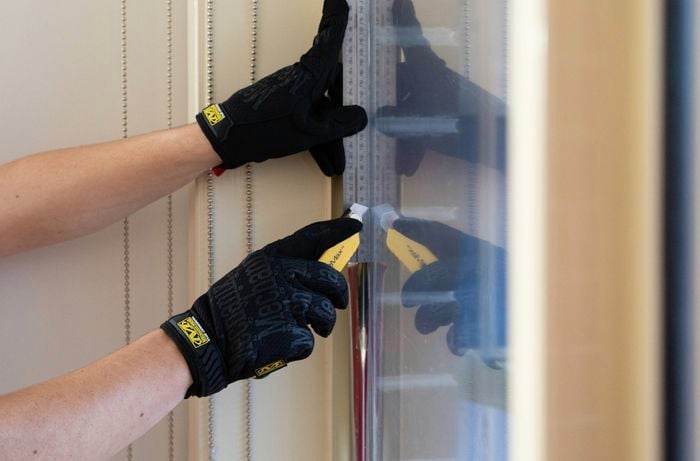 Trim excess window film using utility knife