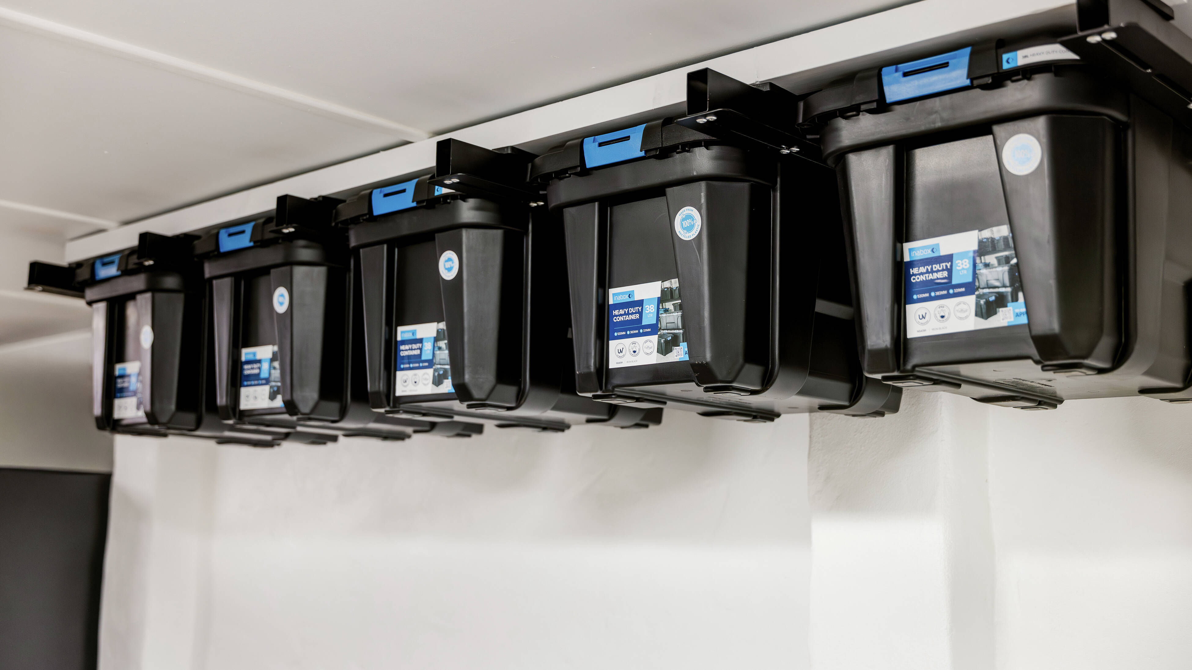 Ceiling-mounted storage tubs installed along a garage ceiling.