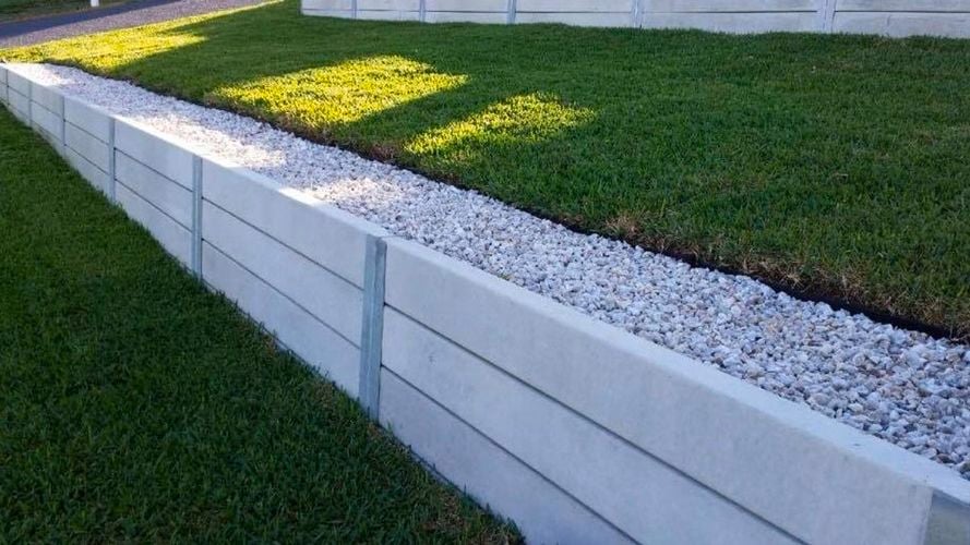 white retaining wall in a lawn