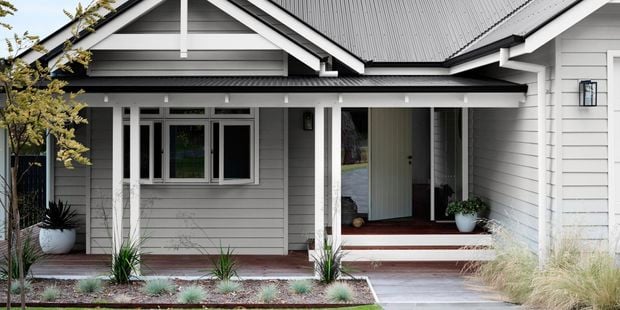 Weatherboard house with steel roofing with colour coordinated roof and exterior.