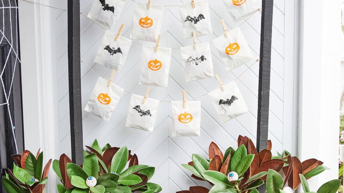 Halloween trick or treat station with ping pong eyeball plants either side