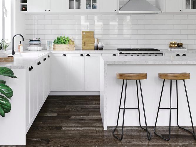 Kitchen with white benchtops, marble benchtop and white tile splashback.