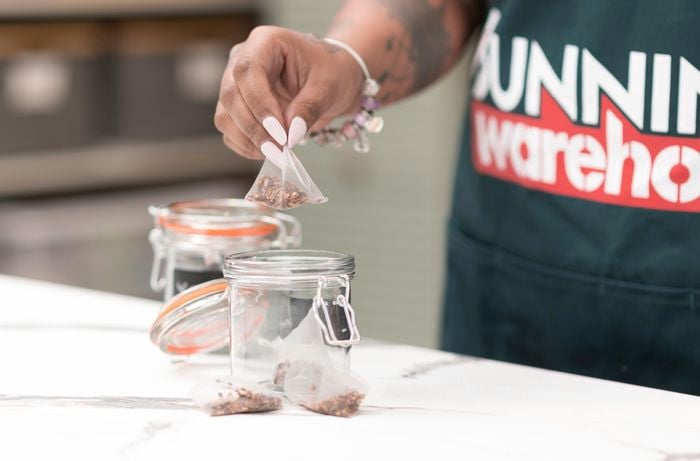 Putting tea bags into a jar.