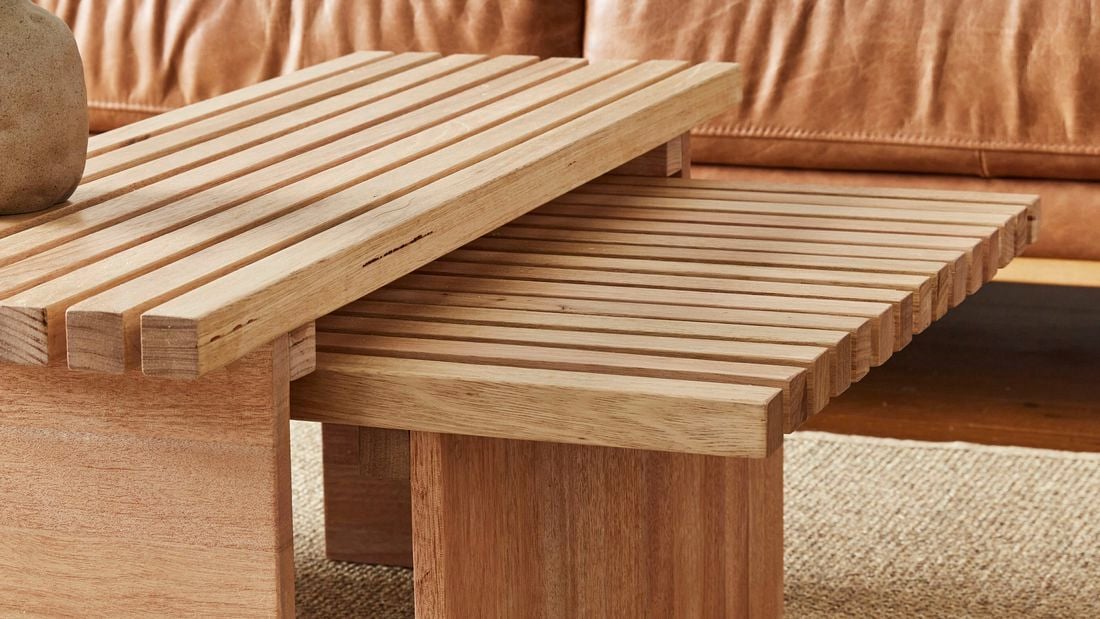 Close up of slatted timber nesting tables in a living room.