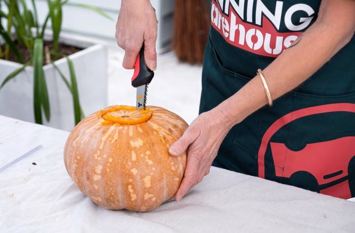 Bunnings team member hollowing out the pumpkin.