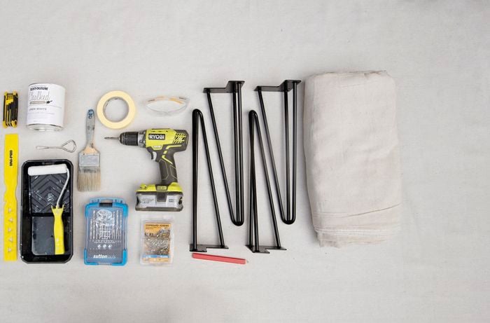 Tools and materials required for the project including drill, paint tray, paint roller and table legs