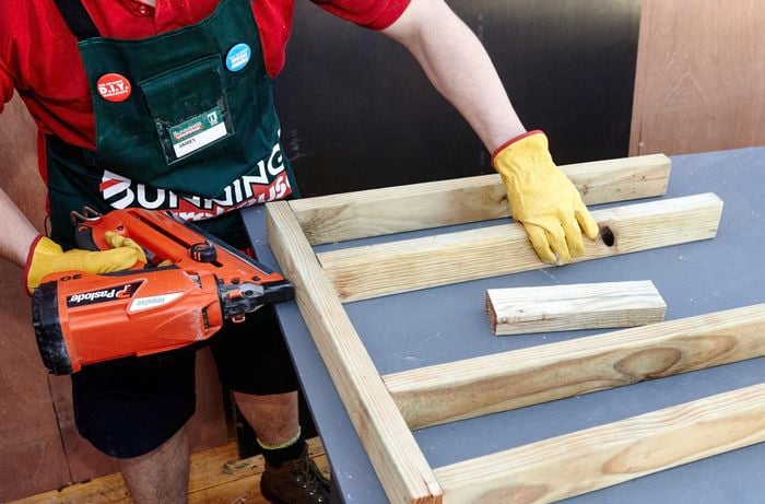Person drilling timber together.