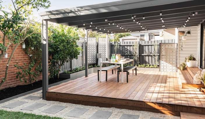 Backyard with decking, outdoor setting and pergola.