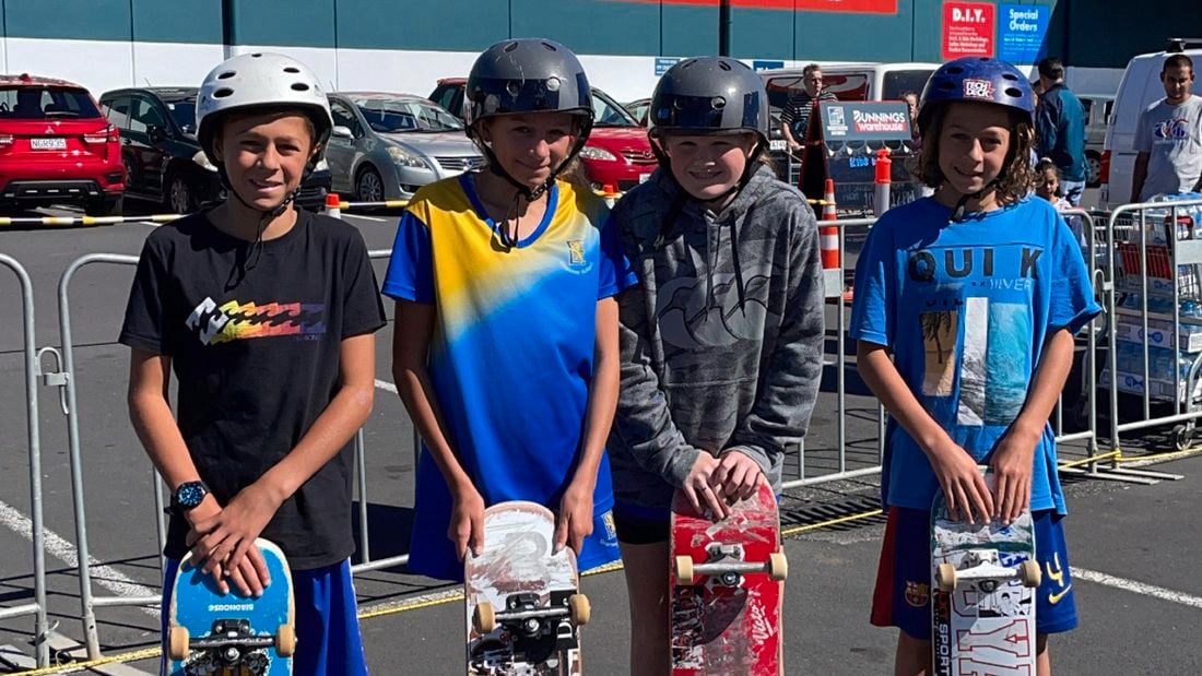 Boys with skateboards out the front of a Bunnings store