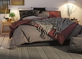 a bedroom with bed and wall art