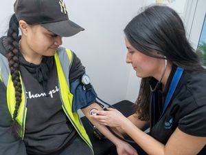 LifeCare individual taking the blood pressure of a patient