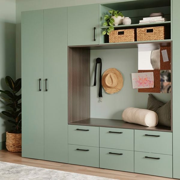 green room with green cabinets and seat in middle 