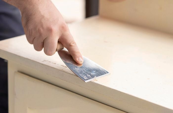 Use paint scraper to remove peeling paint from the surface 