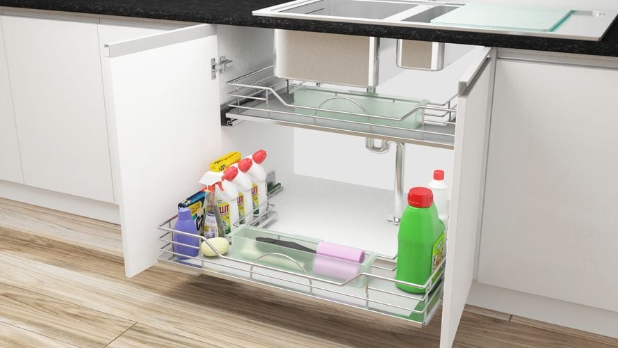 Open kitchen cupboard with pull out shelves for cleaning products