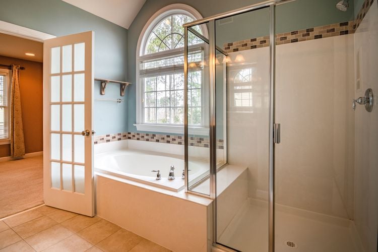 Bathroom with large bath and glass door