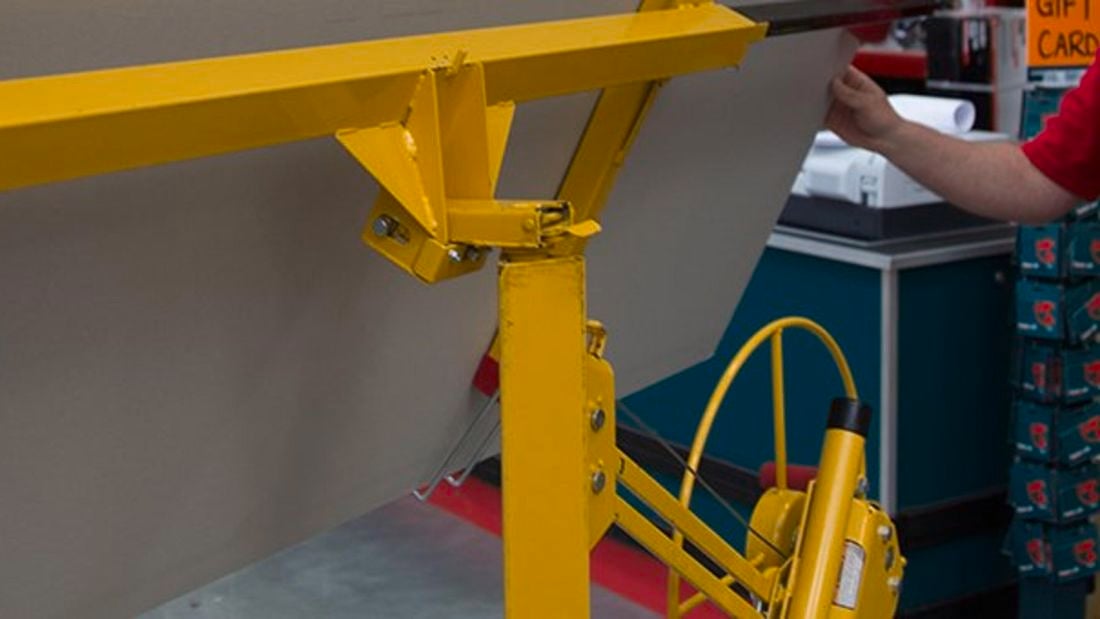 A person operates a panel lift.