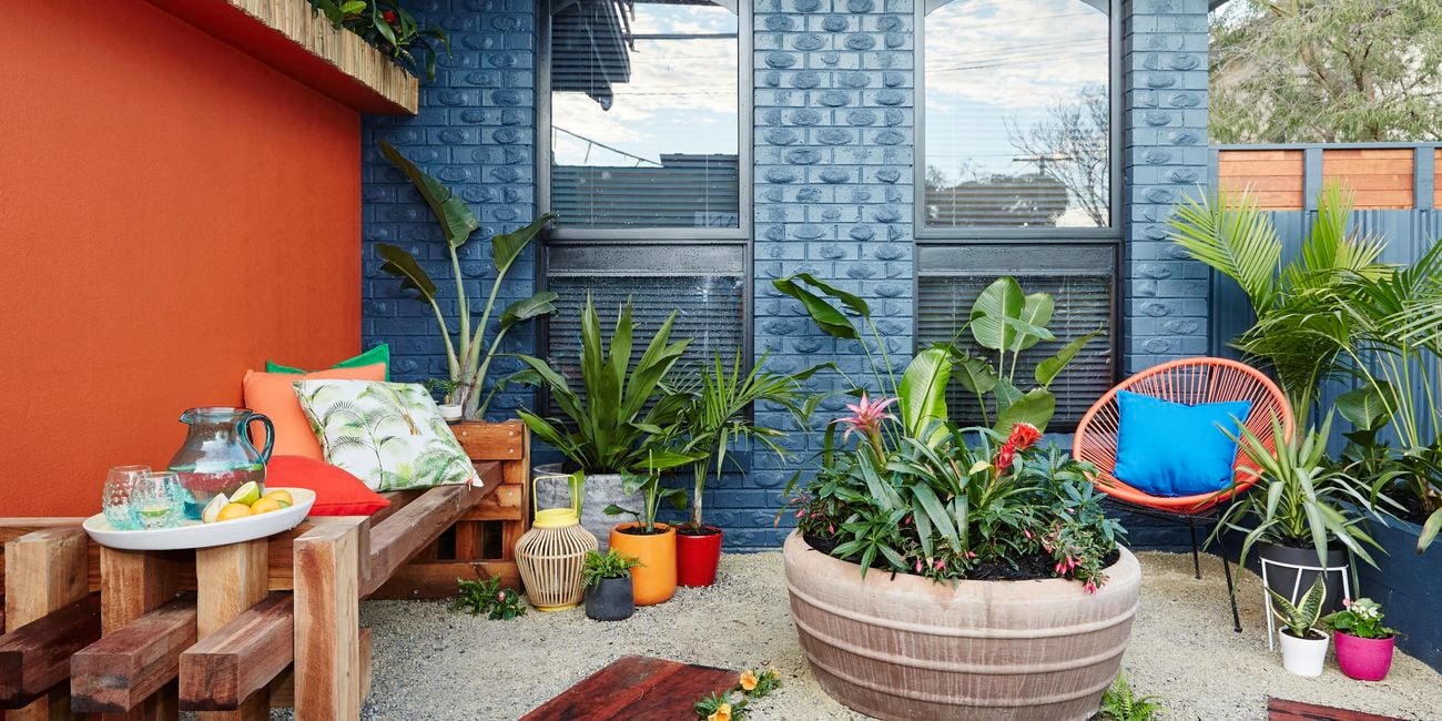 Outdoor area with blue walls and furniture, plants.