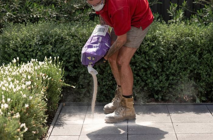 Fill the gaps using paver jointing sand