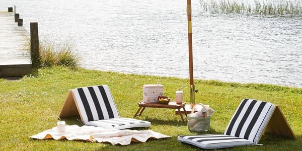padded seating near river with sunshade present 