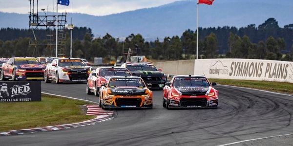 Supercars racing around a track