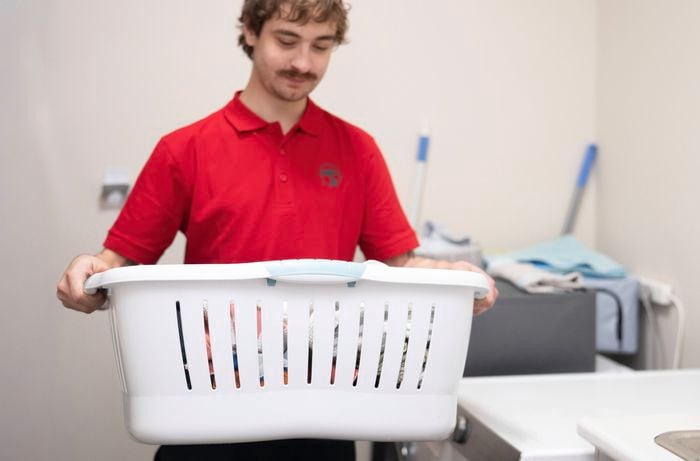 A Bunnings Team Member is removing a laundry basket to clear the space
