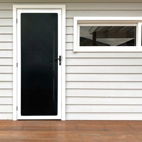 White weatherboard house with black security door