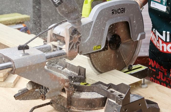 A length of timber being cut with a drop saw