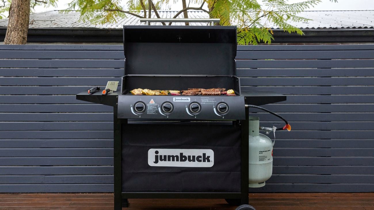 Wide shot of a Jumbuck, flat-top grill, with its’ top open being used to cook a variety of food