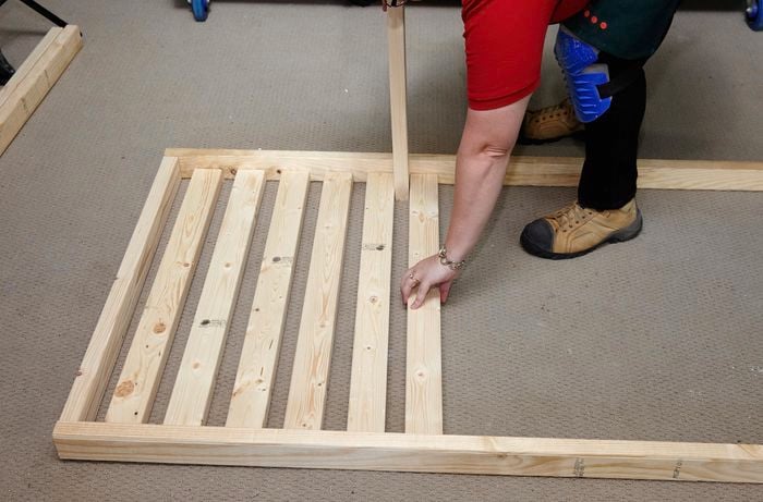 Person building timber bed frame