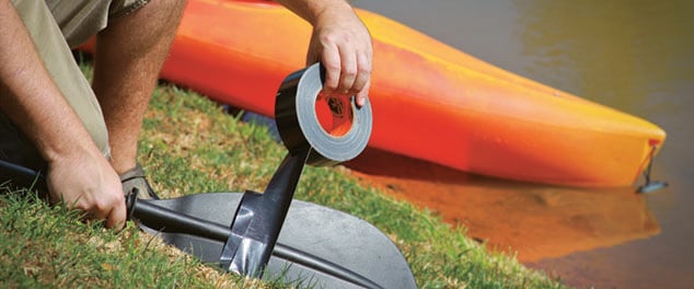 Electrical tape being applied to a canoe paddle