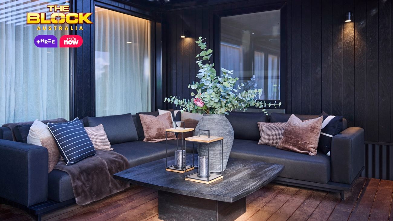 Outdoor area with a lounge and coffee table in it on decking.