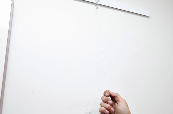 A nylon wire hanger installed on a wall mounted track