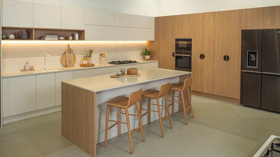 Kitchen - with cream beach top, light timber cupboards and 3 timber stools