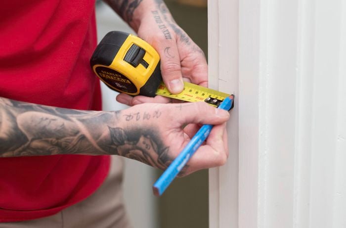 Mark the position for a strike plate on a door frame